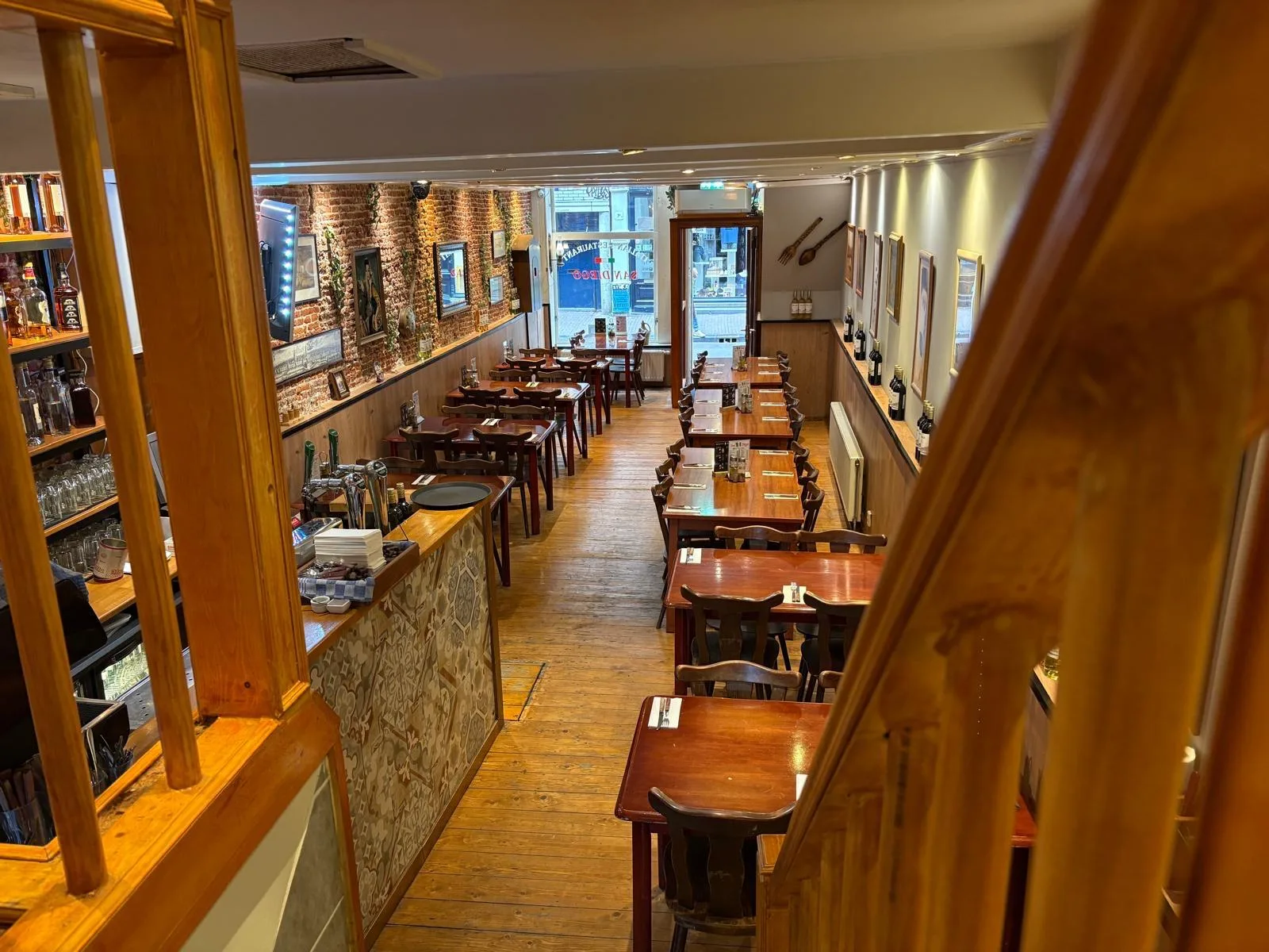Doorkijk door het restaurant langs de bar naar de gedekte tafels